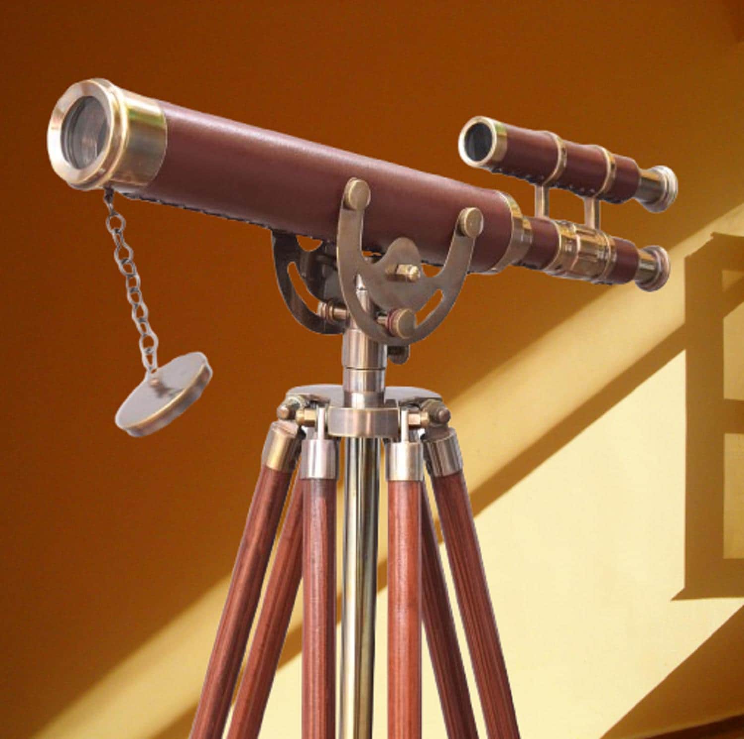 May include: A vintage telescope with a brown leather-clad barrel and brass detailing. It is mounted on a wooden tripod with a polished metal central column. A small secondary scope is attached. The design has a classic nautical or scientific aesthetic, reminiscent of a bygone era.