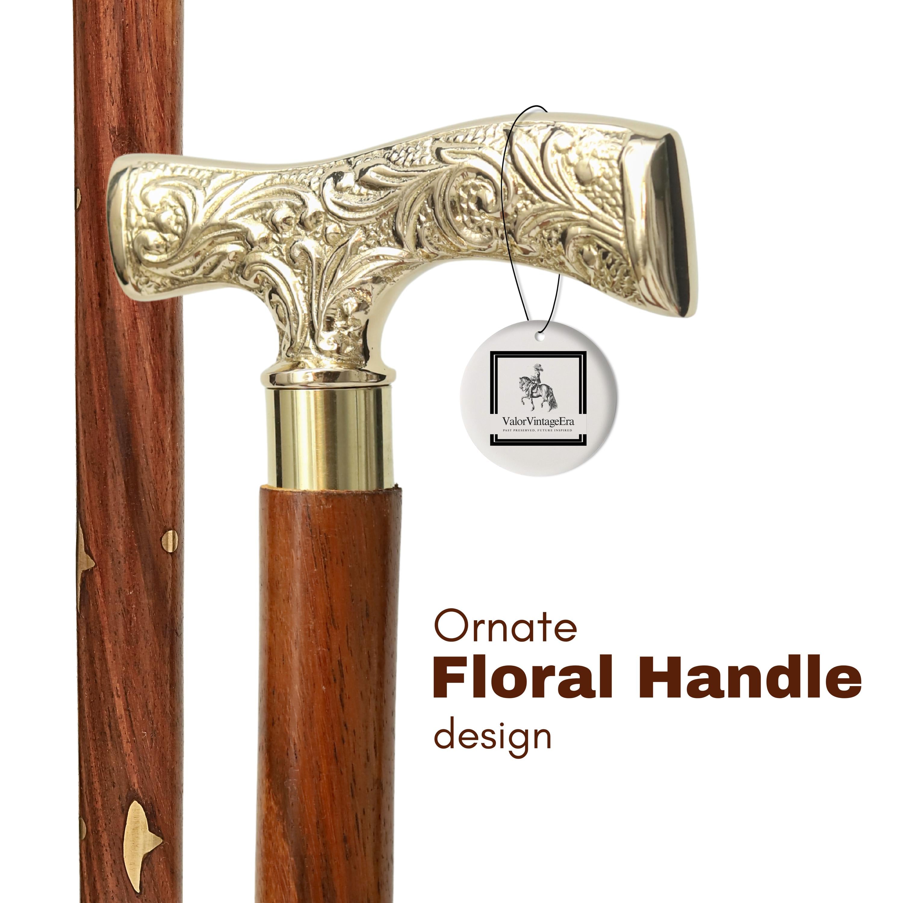 May include: A close-up of a walking stick with an ornate, gold-coloured floral handle. The handle is T-shaped and attached to a dark brown wooden shaft. The text "Ornate Floral Handle design" is visible.
